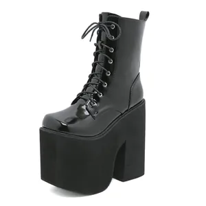Detailed view of women's black patent leather platform boots with super high block heels
