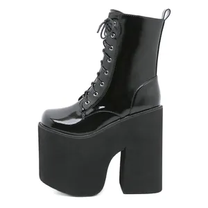 Side view of black patent leather platform boots with extreme block high heels.
