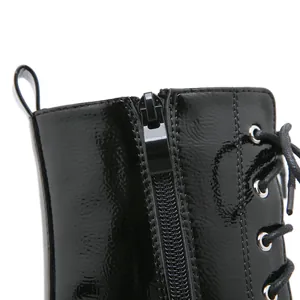 Close-up of black patent leather boot with durable side zipper and laces