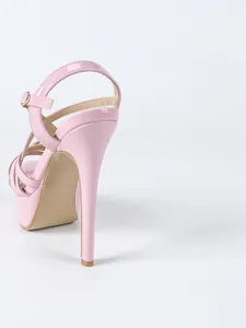 Close-up back view of pink patent leather platform stiletto sandals with ankle straps