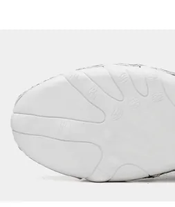Detailed macro view showing octopus-inspired anti-slip white outsole for casual boots