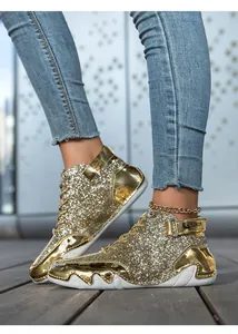 Close-up of gold glitter high-top sneakers with unique octopus-inspired white soles