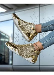 Detail view of gold glitter high-top boots with unique octopus-inspired sole design