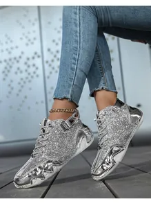Silver glitter high-top boots with reflective metallic panels and unique octopus-style sole