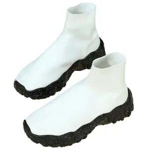 White mid-top fly-knit sock sneakers with black platform speckled sole