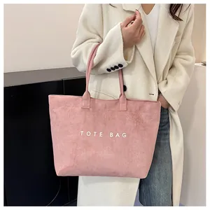 Vue détaillée du sac cabas rose en daim vintage avec inscription blanche TOTE BAG