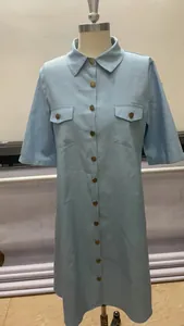 Détail de robe chemise en jean bleu clair à manches courtes avec boutons et poches