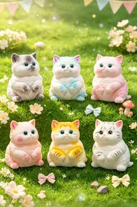 Six colorful cute cat squishy toys arranged on a grassy field with flower props