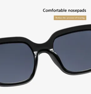 Dettaglio dei naselli confortevoli su occhiali da sole quadrati neri alla moda per donna.