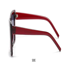 Seitenansicht der übergroßen roten Cat-Eye-Sonnenbrille mit dicken Bügeln auf weißem Grund