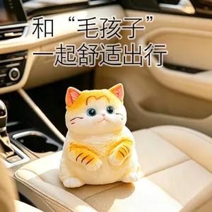 Cute orange and white chubby cat squishy toy for stress relief in a car setting