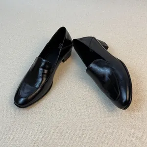 Close-up view of black genuine leather block heel loafers for women in French style