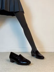 Elegant black leather low heel loafers for women featuring round toe and French style