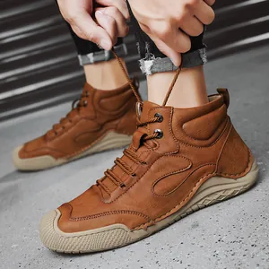 Bottes en cuir marron pour hommes avec lacets, présentées sur un modèle qui les attache