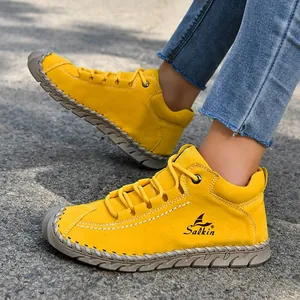 Close-up of hand-stitched details on vibrant yellow leather leisure shoes