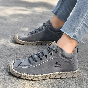 Close-up of grey handmade stitched loafers for women in an outdoor casual setting