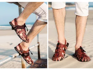 Detailed view of men's leather beach sandals with adjustable drawstring on sand
