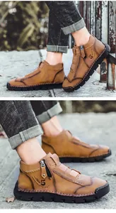 Close-up of men's brown high-top leather casual shoes with side zipper detail