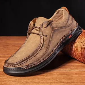 Close-up of handmade brown leather loafers with breathable holes and stitching