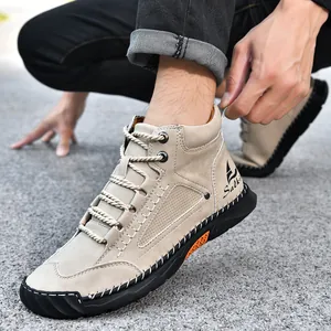 Detailed view of beige hand-stitched men's leather Martin boots worn on asphalt road