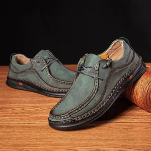 High-quality detailed close-up of men's green leather loafers with handmade stitching details