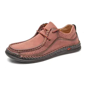 Detail view of men's brownish-red leather driving shoes with hand-stitched accents.