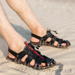 Breathable men's leather beach sandals with hollow-out design on sand