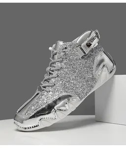 Side detail of metallic silver glitter high-top boots with a unique wavy white octopus sole.