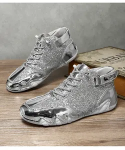 Detailed view of silver glittery high-top sneakers with metallic panels and white soles