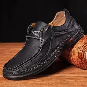Macro view of black men's leather business shoes with elegant hand-stitched detail.
