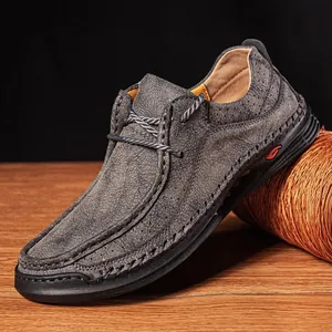 Detailed macro shot of textured grey leather men's driving loafer with handmade stitching