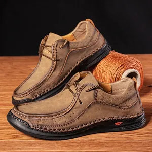 Detailed side view of brown leather men's loafers featuring intricate hand-stitched craftsmanship