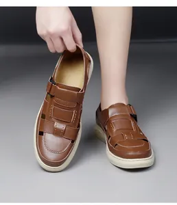 Close-up of brown handmade leather men's sandals featuring a breathable cutout design.
