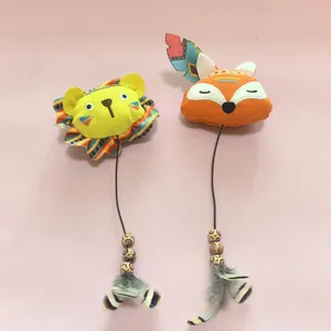 Vue détaillée des jouets pour chats en peluche lion et renard avec plumes colorées.