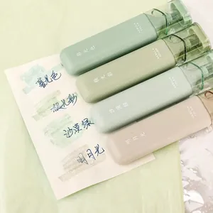 Detailed view showing four glitter highlighters with color swatches on white paper card