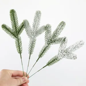 Detailed view of artificial pine needles with realistic white snow flocking effect