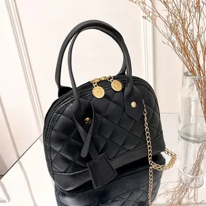 Elegant black quilted shell handbag featuring gold chain strap and top handles for women