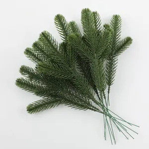 Detailed view of artificial green PE pine needles for Christmas DIY decorations.