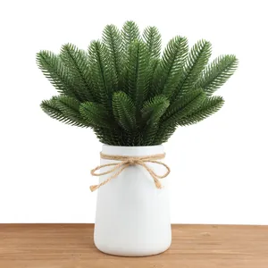 Artificial green pine needles in white vase with jute twine bow for DIY decor