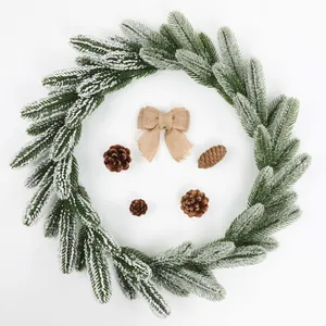 Artificial frosted pine needle wreath with pine cones and burlap bow for Christmas
