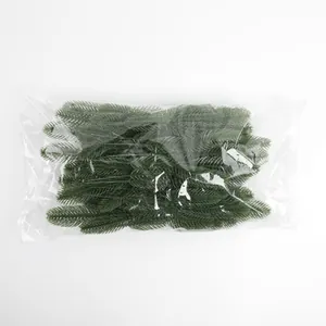 Bulk pack of artificial PE pine needles in a clear plastic bag for DIY decor