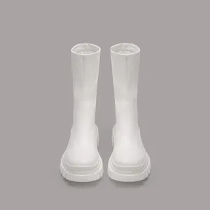 Front view of white mid-calf platform boots featuring a chunky sole and stretch design.