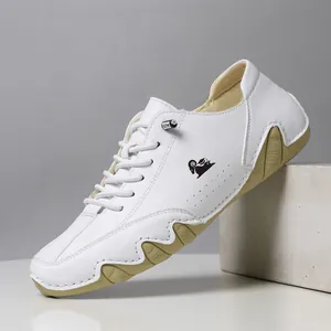 Stylish white leather low-top casual sneakers with tan octopus-style serrated sole
