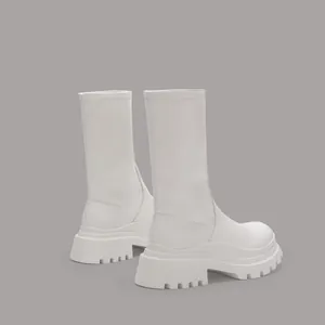 Detailed side view of white platform mid-calf stretch boots with a thick lug sole