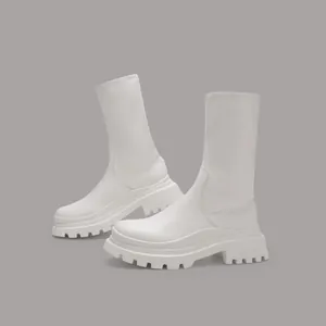Macro view showing the texture and chunky sole of white mid-calf elastic stretch boots