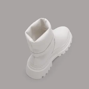 Detail view of white platform mid-calf boots with thick lug sole and stretchy shaft