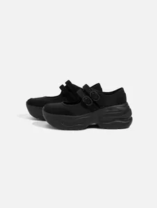 Side view of black platform Mary Jane shoes with double buckle straps and thick soles.