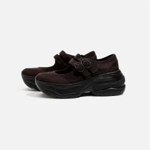 Side view of dark brown suede platform Mary Jane shoes with double buckle straps.