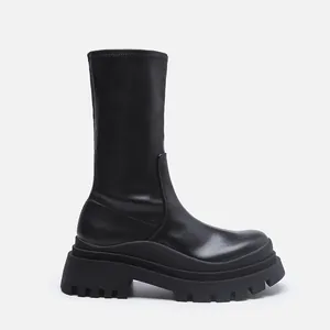 Professional side profile view of a black chunky platform elastic mid-calf boot for women