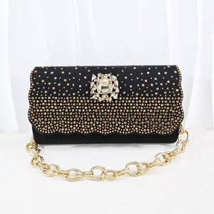 Elegant black evening clutch with gold rhinestones and ornate crystal flower clasp.